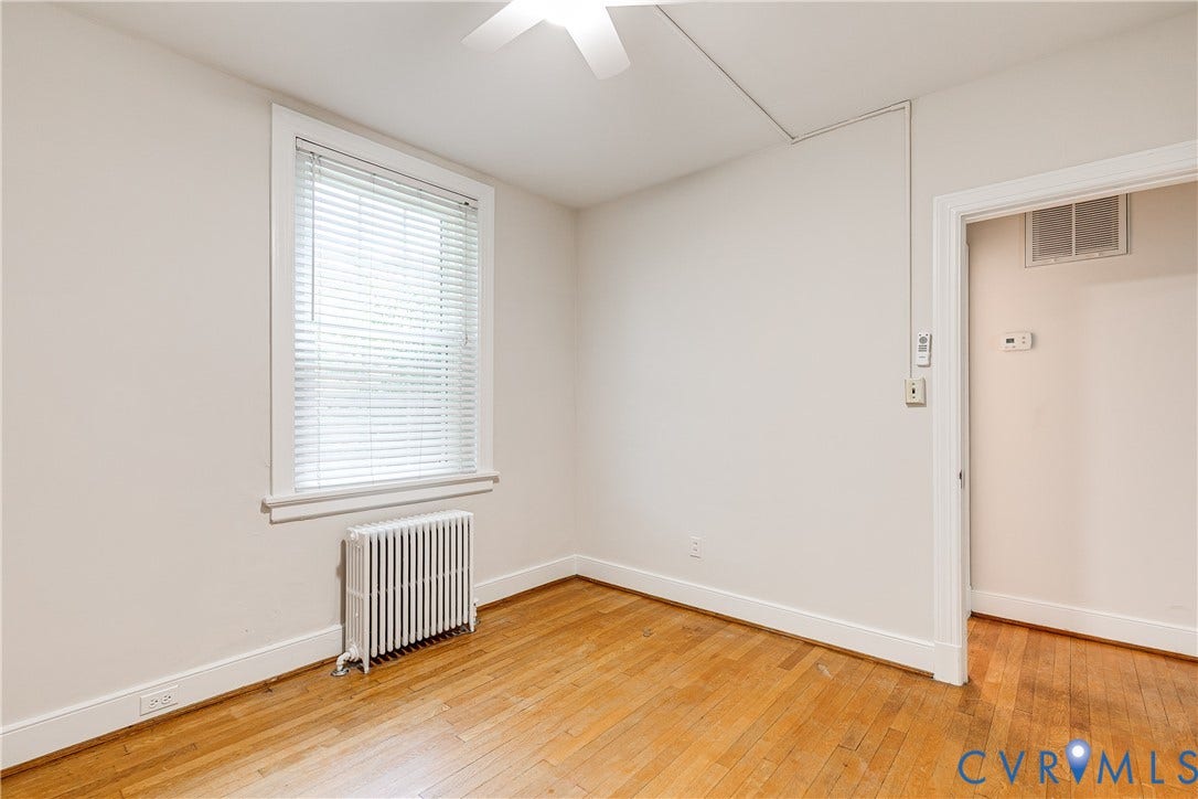 4010 Patterson Avenue, #1stfl, Richmond, VA 23221 Hardwood flooring, window with blinds, baseboard heating unit, ceiling fan, and white trim