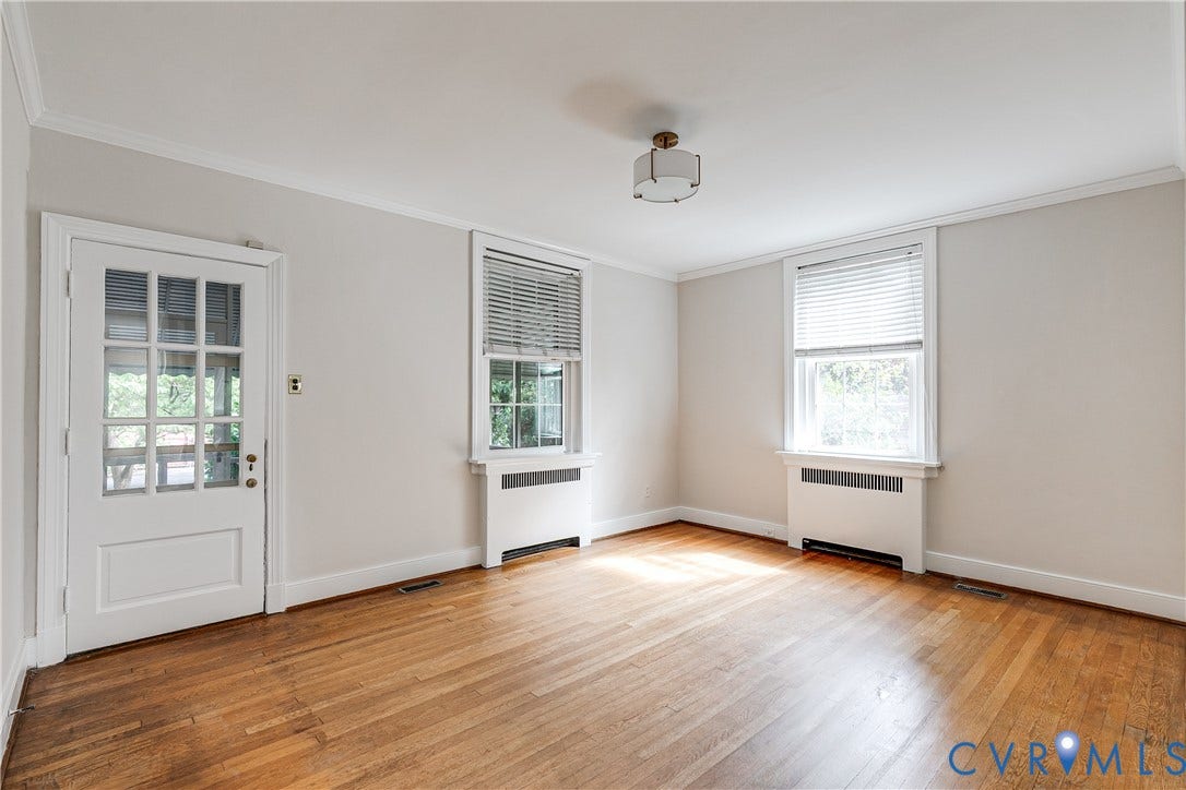 4010 Patterson Avenue, #1stfl, Richmond, VA 23221 Hardwood flooring, crown molding, two windows with blinds, two baseboard heating units, and a glass-paneled door
