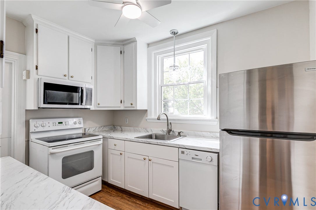 4010 Patterson Avenue, #1stfl, Richmond, VA 23221 Kitchen featuring white cabinetry, integrated microwave, stainless steel refrigerator, and wood-finish flooring