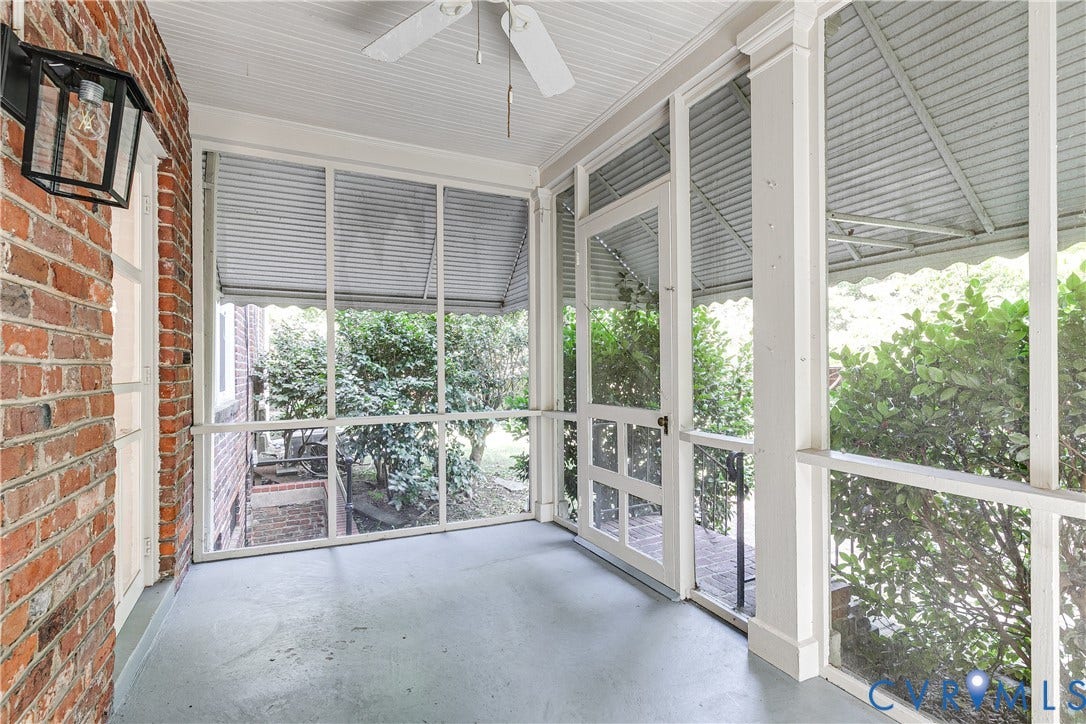 4010 Patterson Avenue, #1stfl, Richmond, VA 23221 Screened porch featuring a ceiling fan, brick exterior wall, and outdoor wall sconce