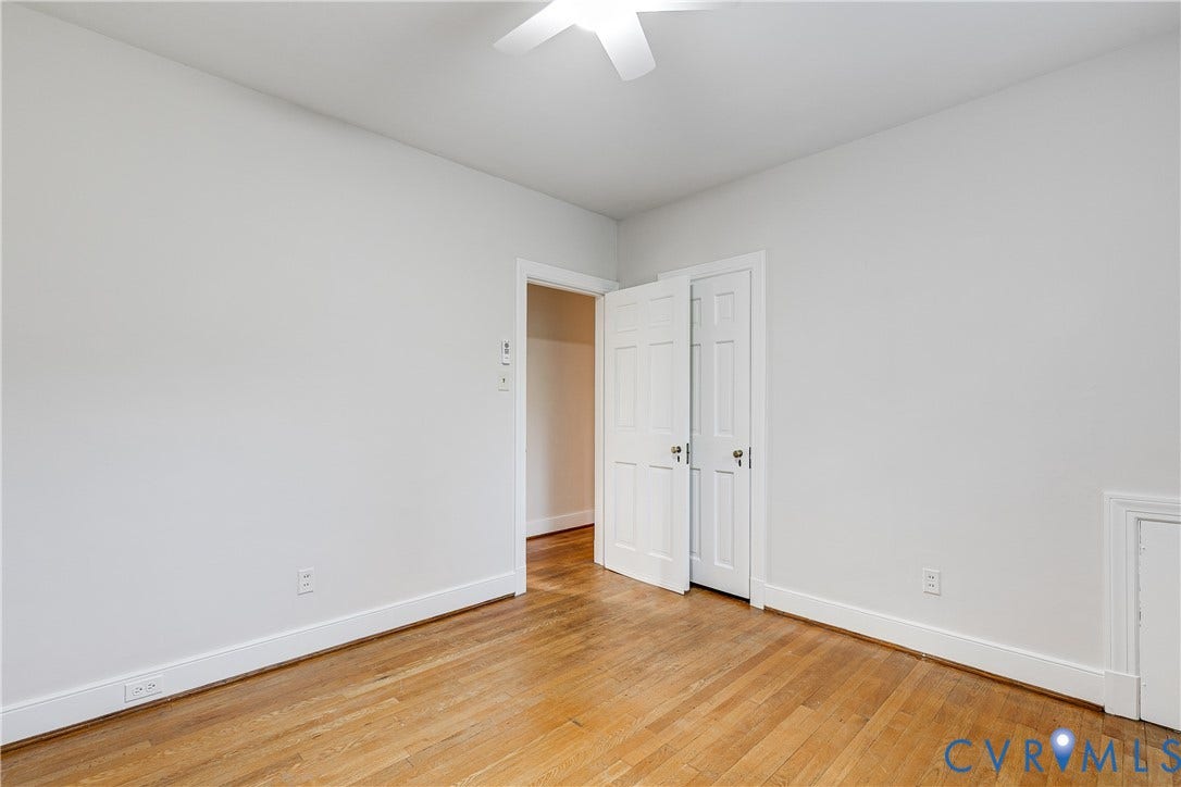 4010 Patterson Avenue, #1stfl, Richmond, VA 23221 Hardwood flooring, crisp white walls, white trim, ceiling fan, and bi-fold closet doors