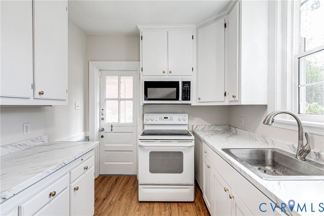 4010 Patterson Avenue, #1stfl, Richmond, VA 23221 Kitchen featuring white cabinetry with gold-toned hardware, wood-finish flooring, white stone-look countertops, an undermount stainless steel sink, and a white electric range with an over-the-range microwave