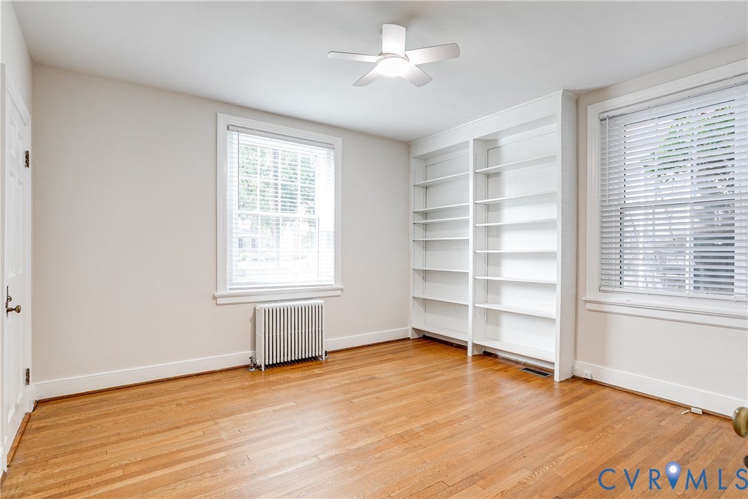 4010 Patterson Avenue, #1stfl, Richmond, VA 23221 Hardwood flooring throughout, built-in shelving, two windows with blinds, and a ceiling fan