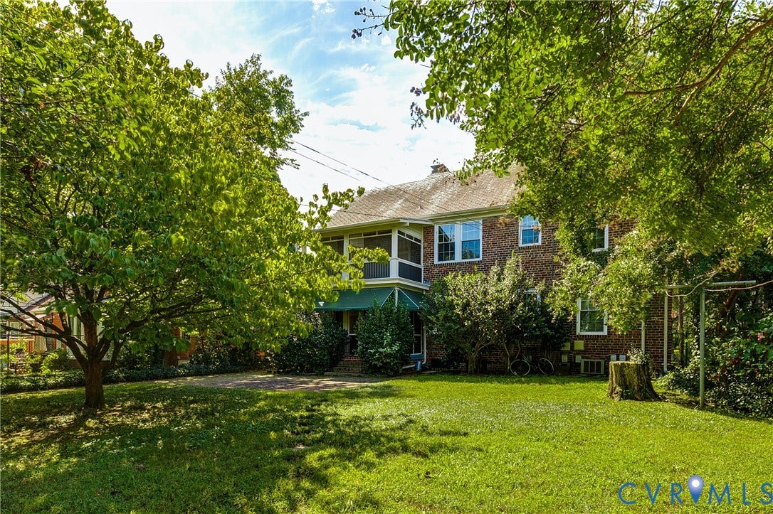 4010 Patterson Avenue, #1stfl, Richmond, VA 23221 Brick exterior residence featuring a screened porch, multiple windows, and a green awning