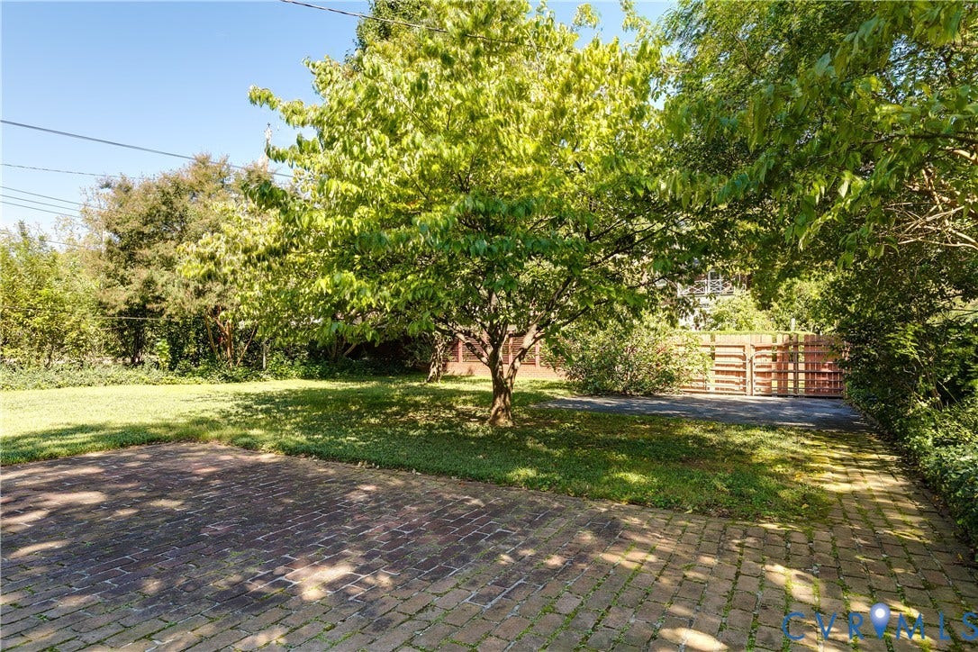 4010 Patterson Avenue, #1stfl, Richmond, VA 23221 Expansive grounds featuring mature shade trees, brick paver driveway, and gated entry
