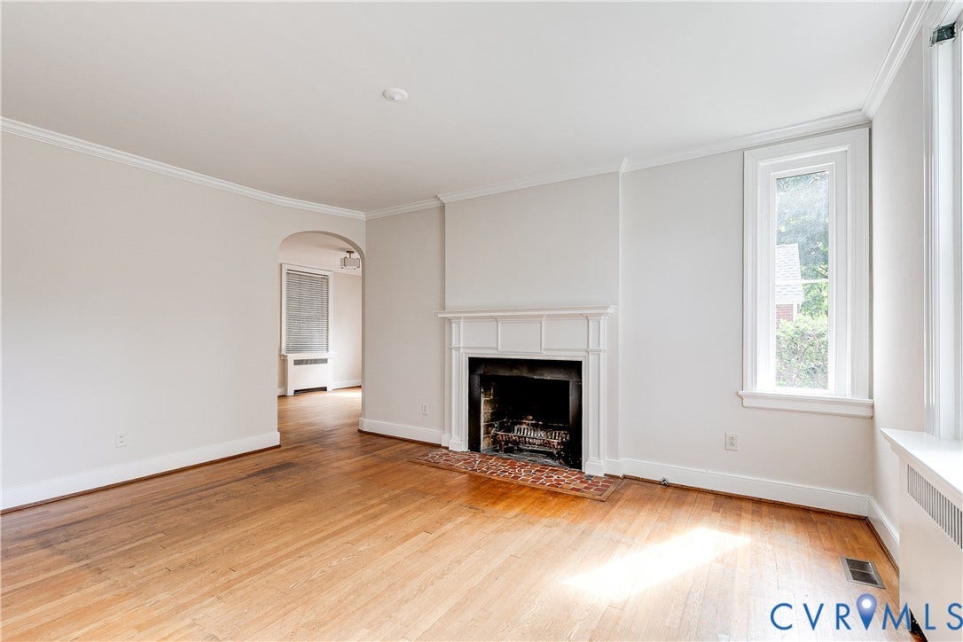 4010 Patterson Avenue, #1stfl, Richmond, VA 23221 Hardwood flooring, decorative fireplace with mantel, arched doorway, and crown molding