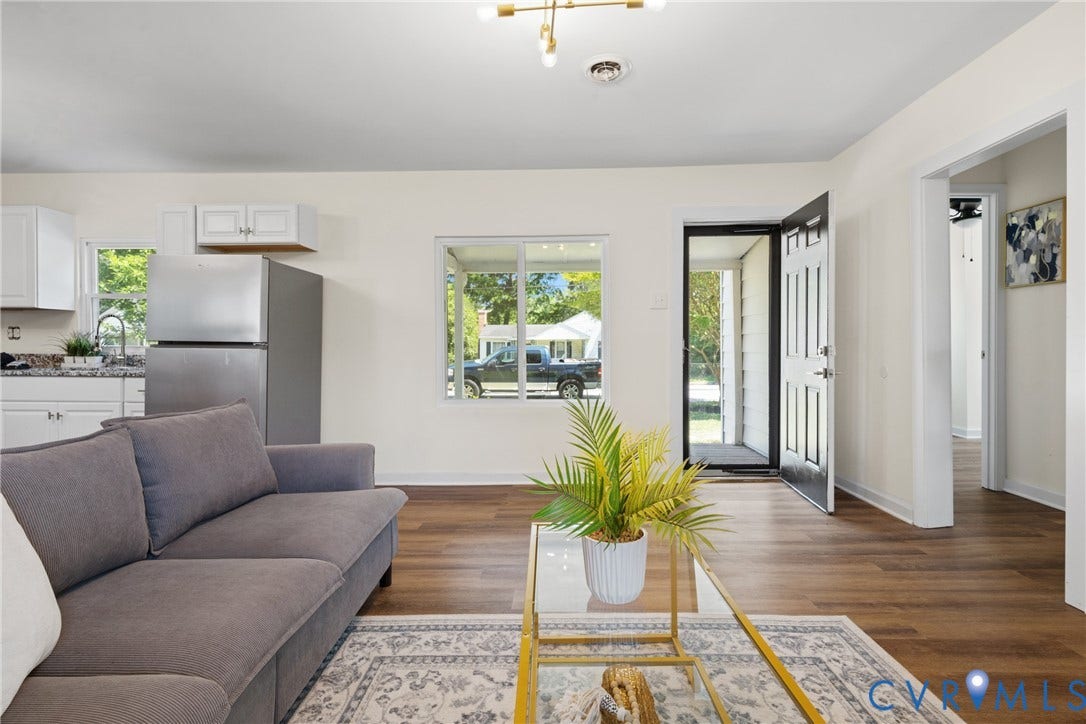 2911 Poplar Street, Hopewell, VA 23860 Open-concept living space featuring wood-finish flooring, white walls, and a contemporary ceiling fixture
