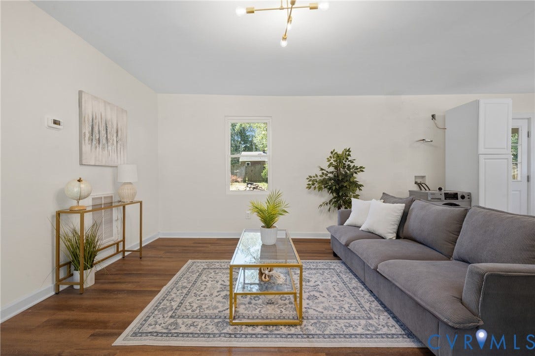 2911 Poplar Street, Hopewell, VA 23860 Spacious room featuring wood-finish flooring, a contemporary ceiling light fixture, and a single window