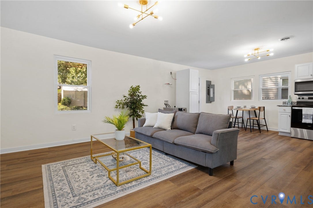 2911 Poplar Street, Hopewell, VA 23860 Open-concept living area featuring wood-finish flooring, white walls, and contemporary ceiling light fixtures