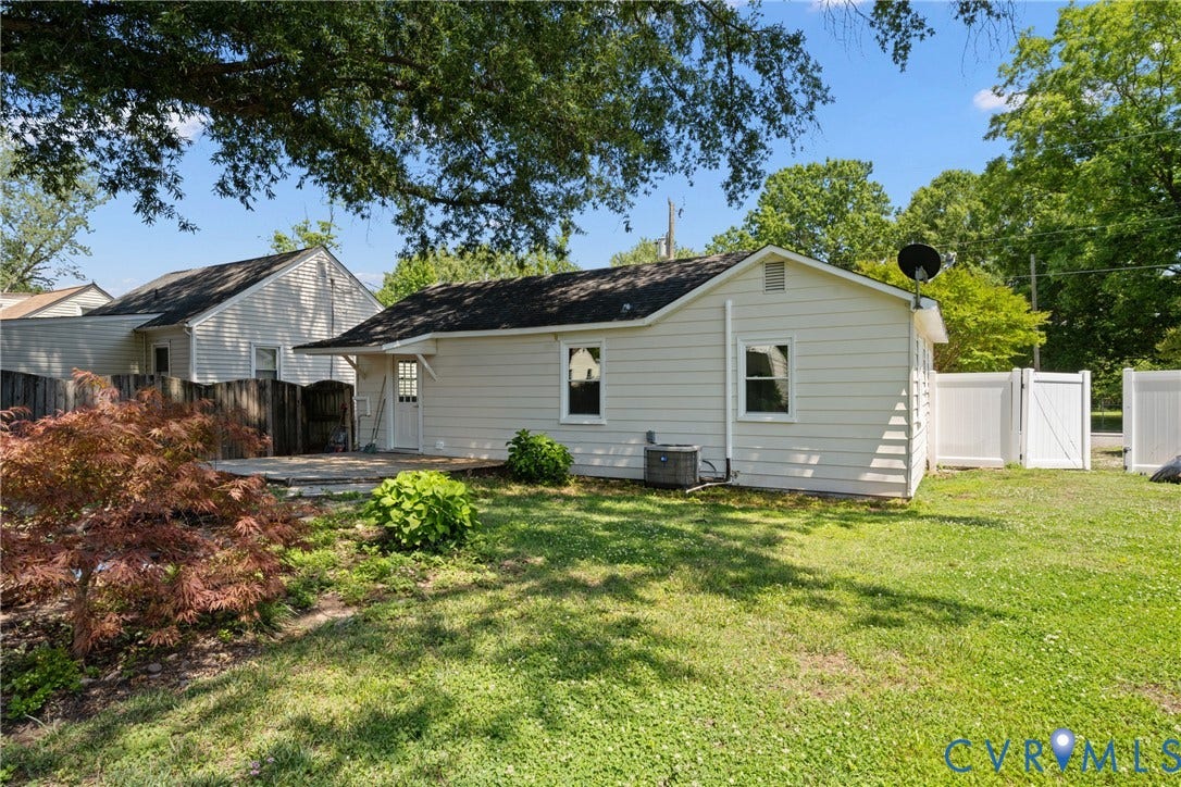 2911 Poplar Street, Hopewell, VA 23860 Expansive backyard featuring a manicured lawn, established landscaping, and a patio area