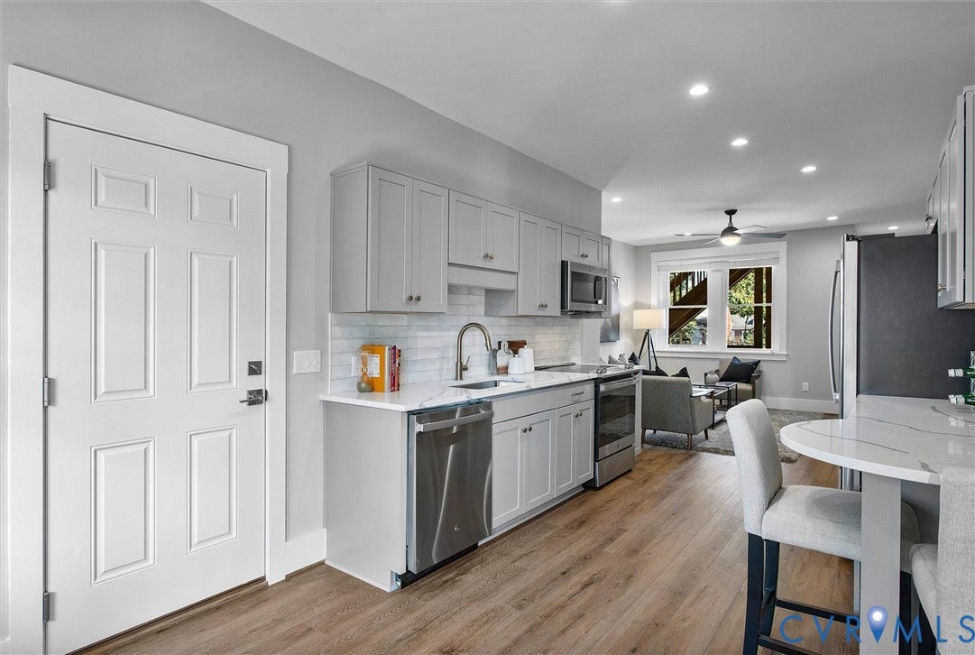 2902 Idlewood, #5, Richmond, VA 23221 Light-toned wood-finish flooring complements the white paneled door
