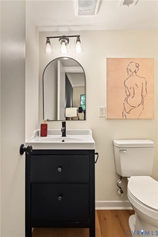 10272 Iron Mill Road, North Chesterfield, VA 23235 Bathroom vanity with integrated sink, matte black faucet, and arched mirror