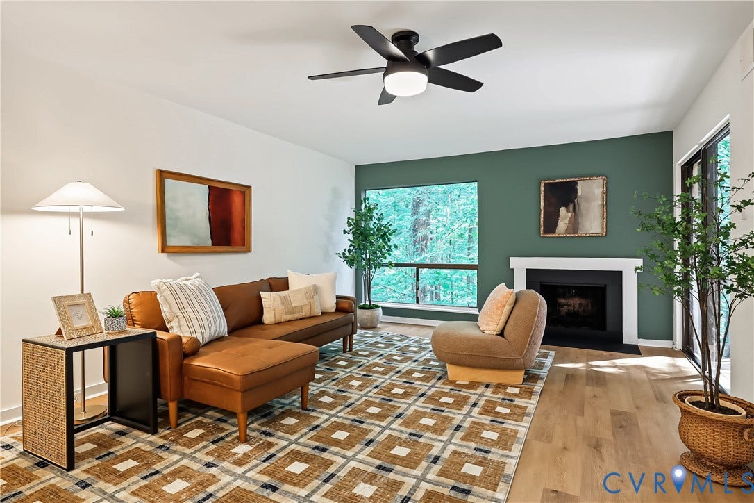 10272 Iron Mill Road, North Chesterfield, VA 23235 Living area featuring wood-finish flooring, a fireplace with a white mantel, and a black ceiling fan with integrated lighting