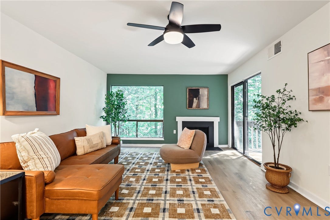 10272 Iron Mill Road, North Chesterfield, VA 23235 Living area featuring wood-finish flooring, a contemporary ceiling fan, and a fireplace with a white mantel