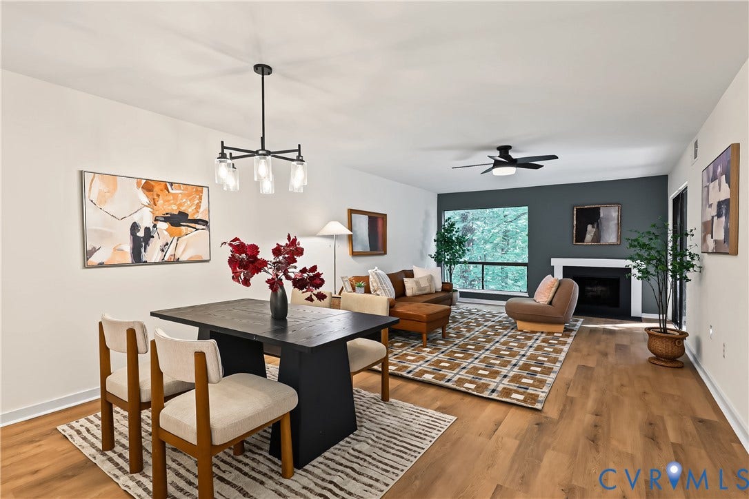 10272 Iron Mill Road, North Chesterfield, VA 23235 Open-concept living area featuring wood-finish flooring, a contemporary fireplace with a white mantel, and a wall-mounted ceiling fan