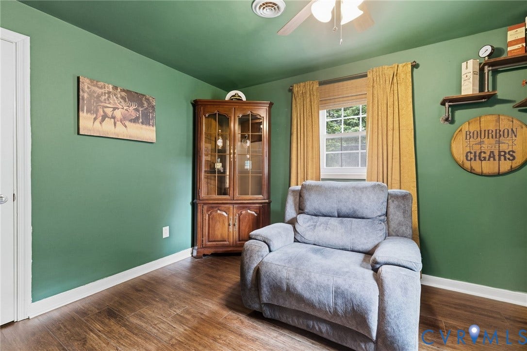 6723 Cherry Road, Woodhaven Shores, Quinton, VA 23141 Wood-finish flooring, vibrant green walls, and a window with natural light