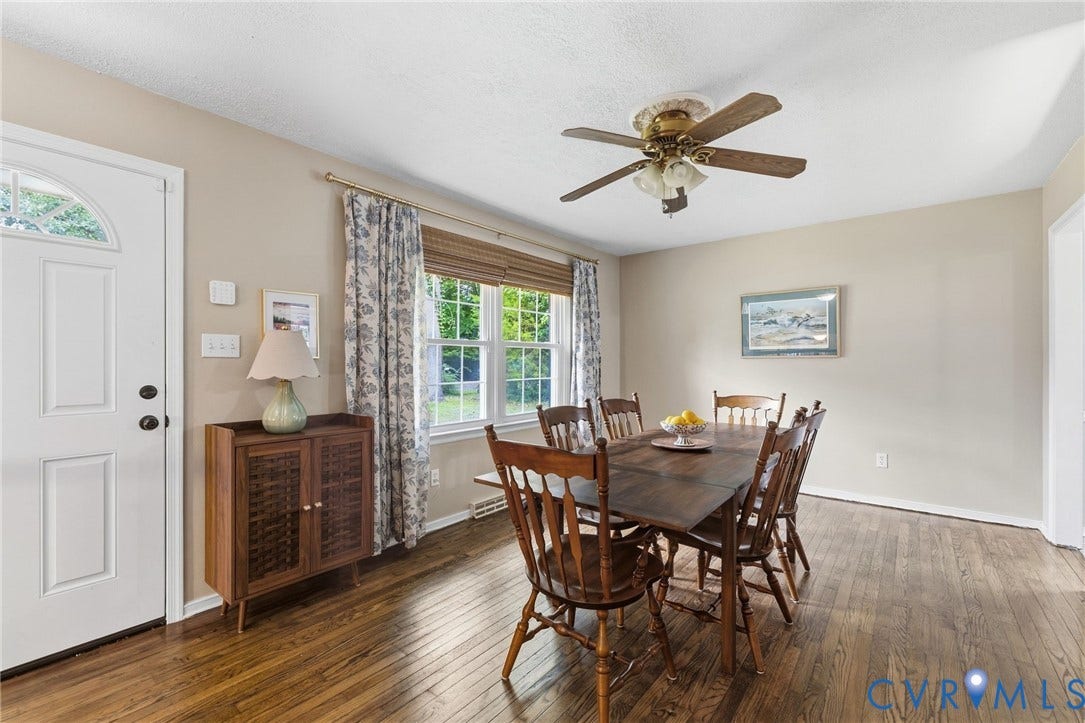 6723 Cherry Road, Woodhaven Shores, Quinton, VA 23141 Elegant dining room showcasing rich wood-finish flooring, a solid wood dining table with turned spindle chairs, and a coordinating wood dresser with decorative hardware