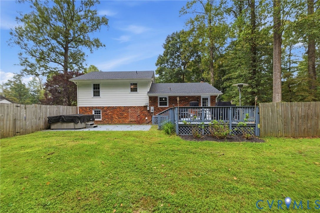 6723 Cherry Road, Woodhaven Shores, Quinton, VA 23141 Expansive backyard featuring a wood privacy fence, a multi-level wood deck, and a concrete patio