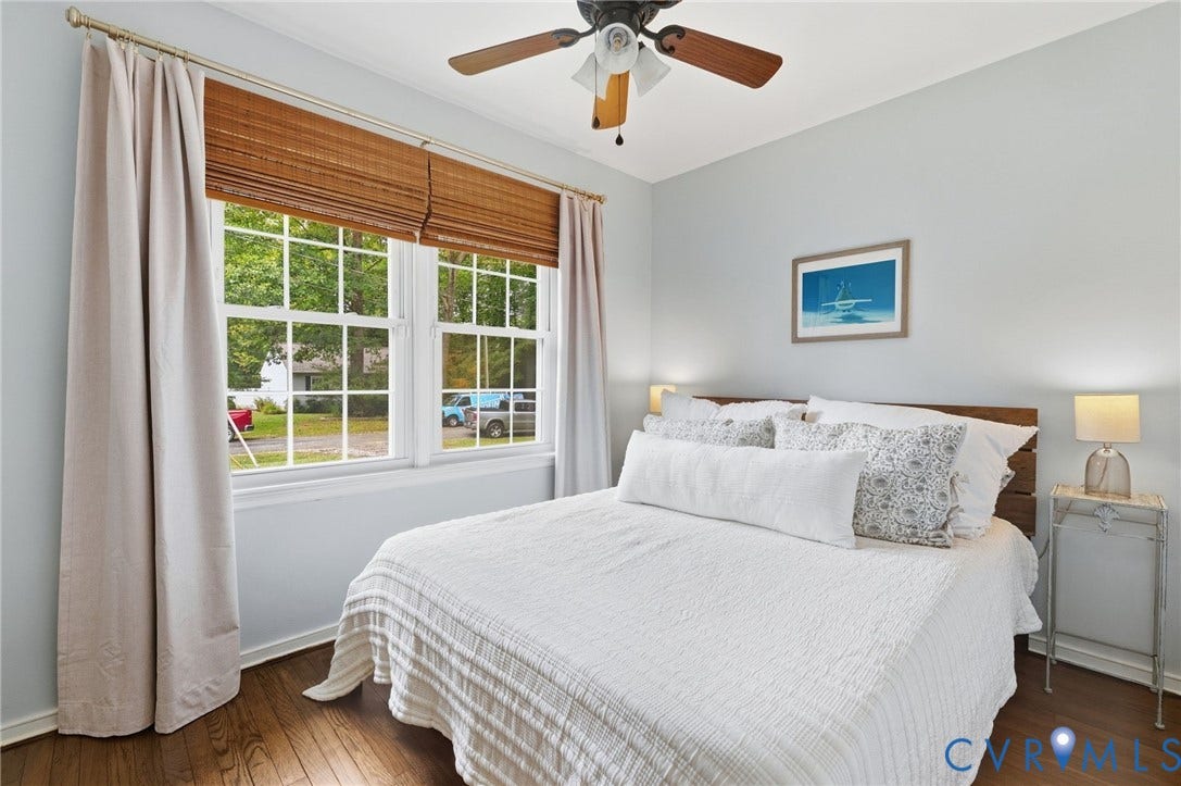 6723 Cherry Road, Woodhaven Shores, Quinton, VA 23141 Wood-finish flooring, white double-hung windows, and a ceiling fan with light fixture