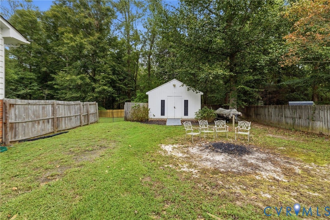 6723 Cherry Road, Woodhaven Shores, Quinton, VA 23141 Expansive backyard with a dedicated storage shed, mature perimeter trees, and wood fencing