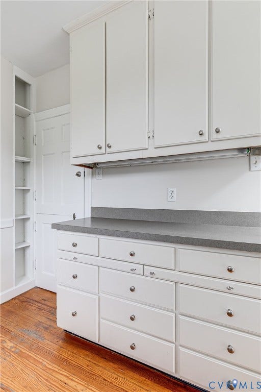 4010 Patterson Avenue, #2ndfl, Richmond, VA 23221 Extensive white cabinetry with varied drawer sizes, gray countertop, built-in shelving, and wood-finish flooring