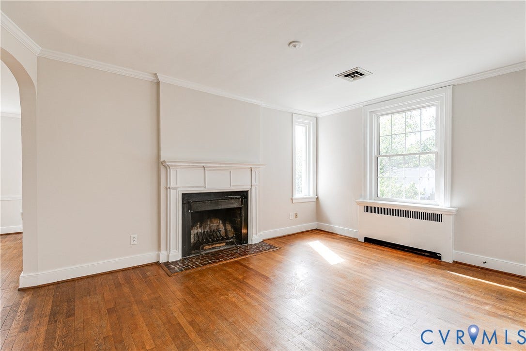 4010 Patterson Avenue, #2ndfl, Richmond, VA 23221 Wood-finish flooring, white crown molding, a fireplace with a detailed mantel, and multiple windows