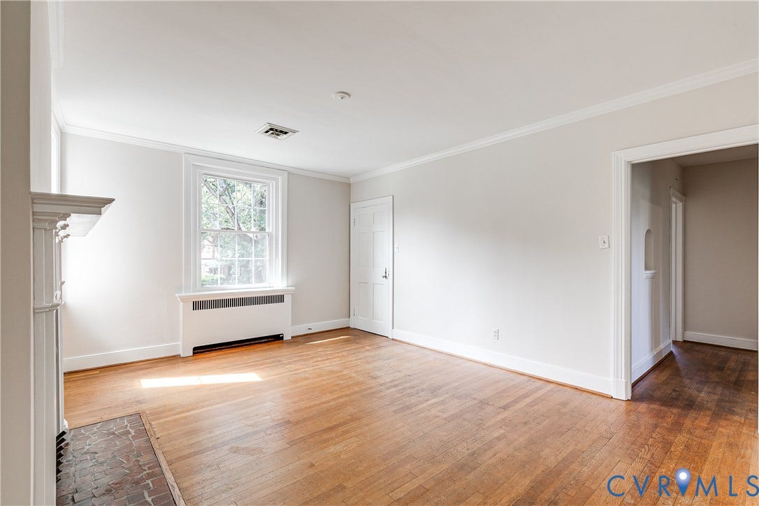 4010 Patterson Avenue, #2ndfl, Richmond, VA 23221 Wood-finish flooring, a traditional fireplace with a white mantel, a window with muntins, and crown molding