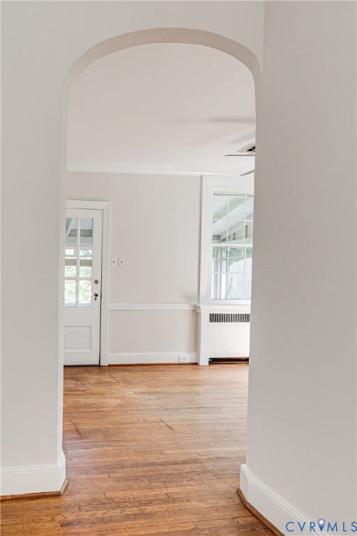 4010 Patterson Avenue, #2ndfl, Richmond, VA 23221 Archway opening with wood-finish flooring, white trim, and a paneled door with glass inserts