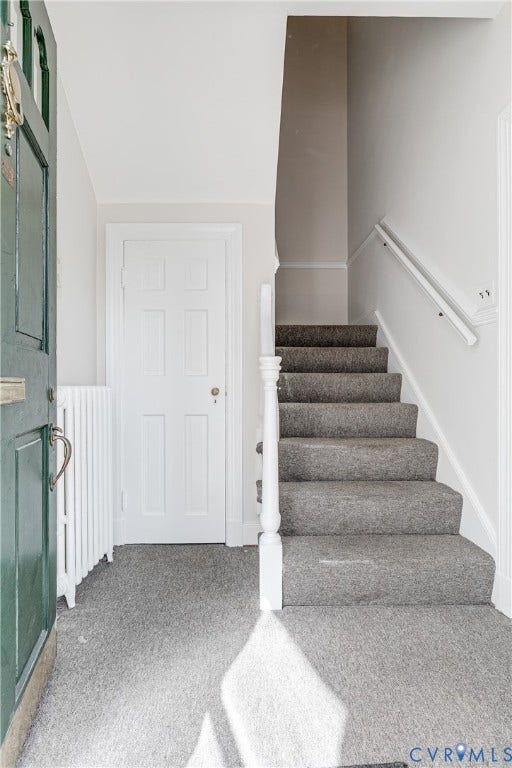 4010 Patterson Avenue, #2ndfl, Richmond, VA 23221 Carpeted stairway with white railing, paneled interior door, and green entryway door