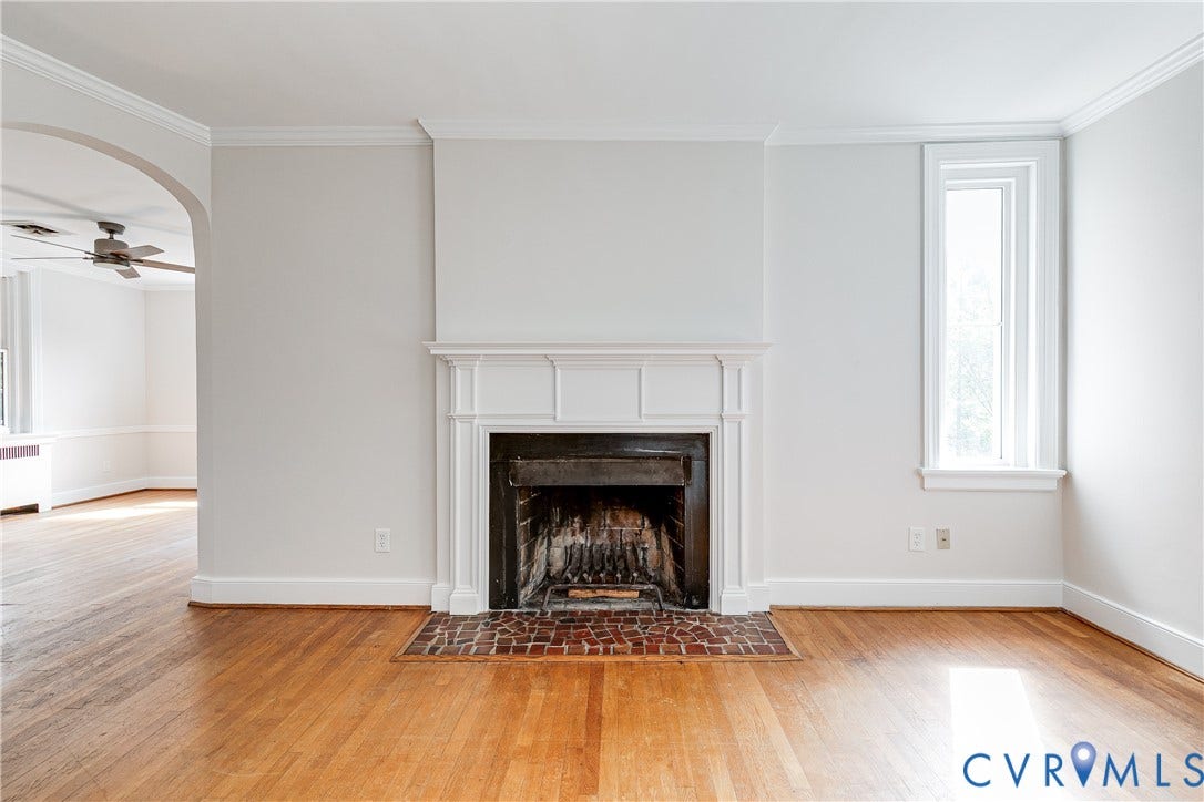 4010 Patterson Avenue, #2ndfl, Richmond, VA 23221 Hardwood flooring, fireplace with white mantel, brick hearth, arched doorway, and crown molding
