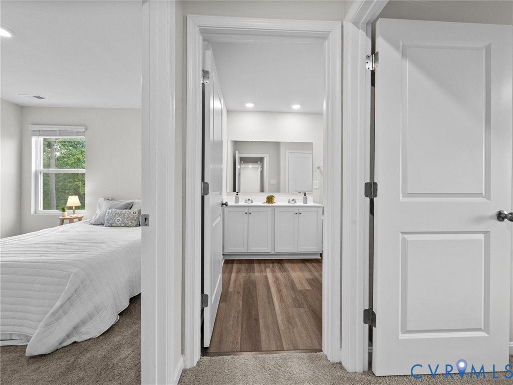 6901 Switch Cane Court, The Arbors, New Kent, VA 23141 White panel doors, recessed lighting, wood-finish flooring, and a double vanity with white cabinetry