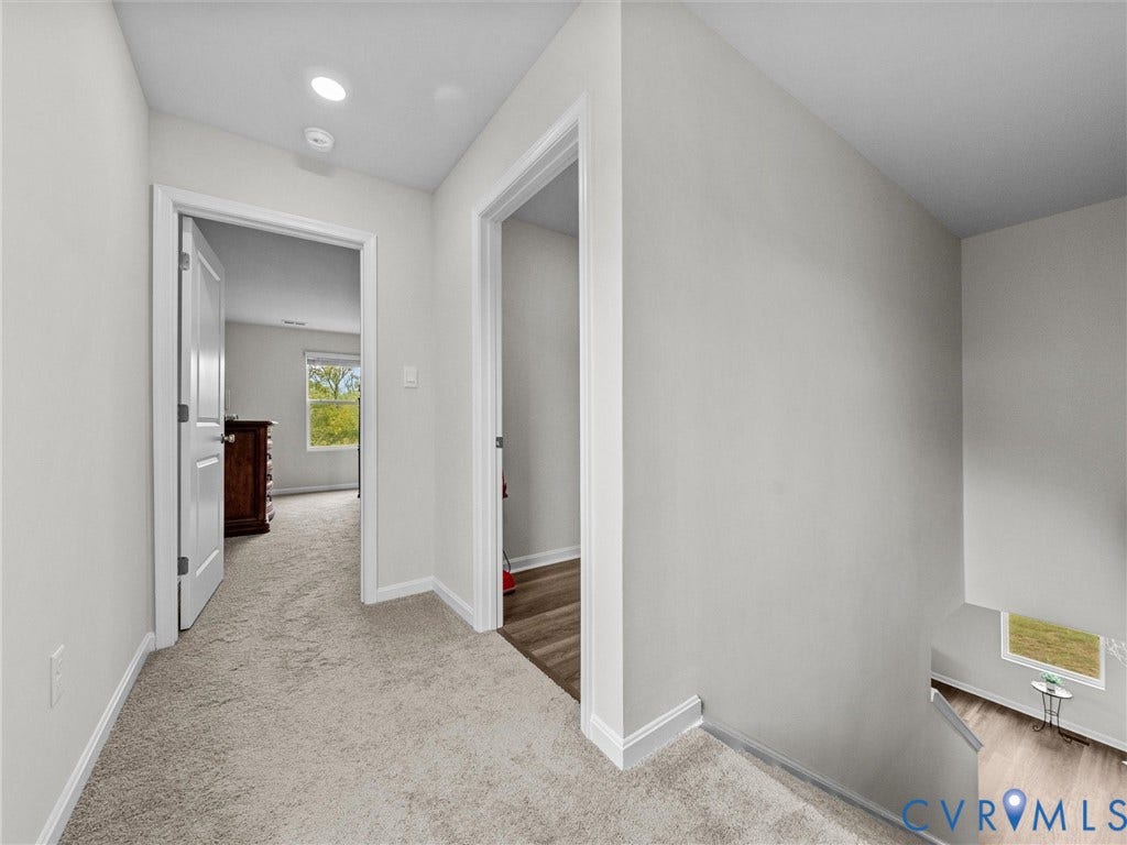 6901 Switch Cane Court, The Arbors, New Kent, VA 23141 Light-colored wall finishes, recessed ceiling lighting, and carpeted flooring in the hallway