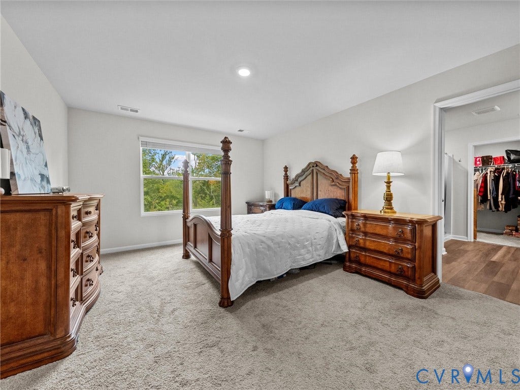 6901 Switch Cane Court, The Arbors, New Kent, VA 23141 Recessed ceiling lighting, window with exterior scenery, light-toned wall paint, carpeted flooring, and a separate closet area with wood-finish flooring