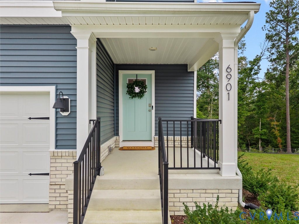 6901 Switch Cane Court, The Arbors, New Kent, VA 23141 Covered entryway with white columns, light blue siding, and white brick accents