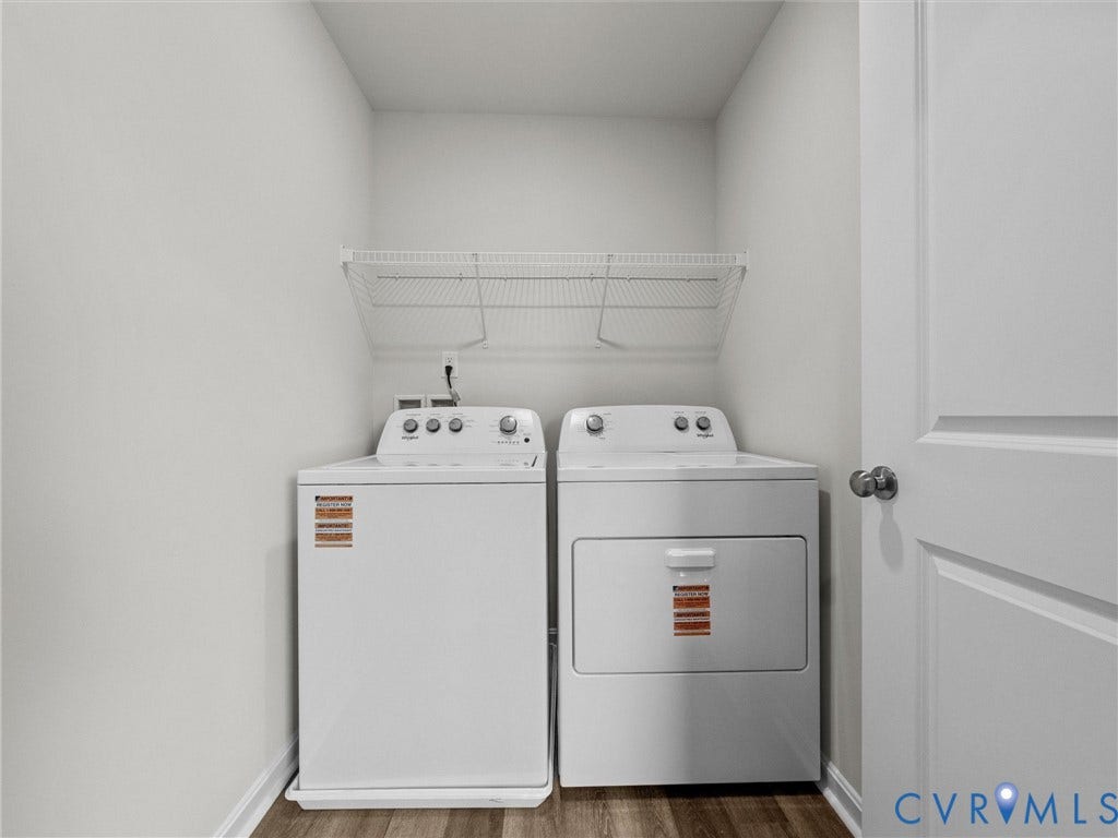 6901 Switch Cane Court, The Arbors, New Kent, VA 23141 Dedicated laundry area featuring a full-size washer and dryer, wire shelving, and wood-finish flooring