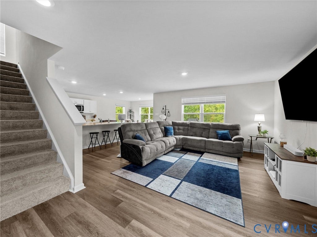 6901 Switch Cane Court, The Arbors, New Kent, VA 23141 Open-concept living area with wood-finish flooring, recessed lighting, and a kitchen counter with seating