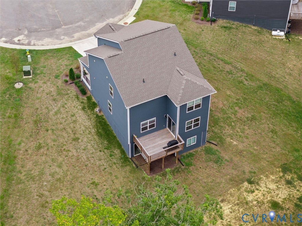 6901 Switch Cane Court, The Arbors, New Kent, VA 23141 Two-story exterior with dark blue siding, a multi-level roof, and an elevated wood deck