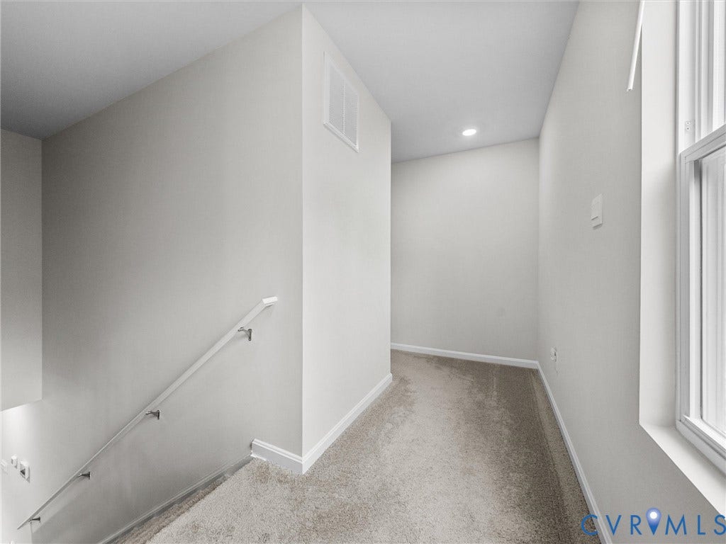 6901 Switch Cane Court, The Arbors, New Kent, VA 23141 Carpeted hallway with a window, contemporary wall sconce, and recessed lighting