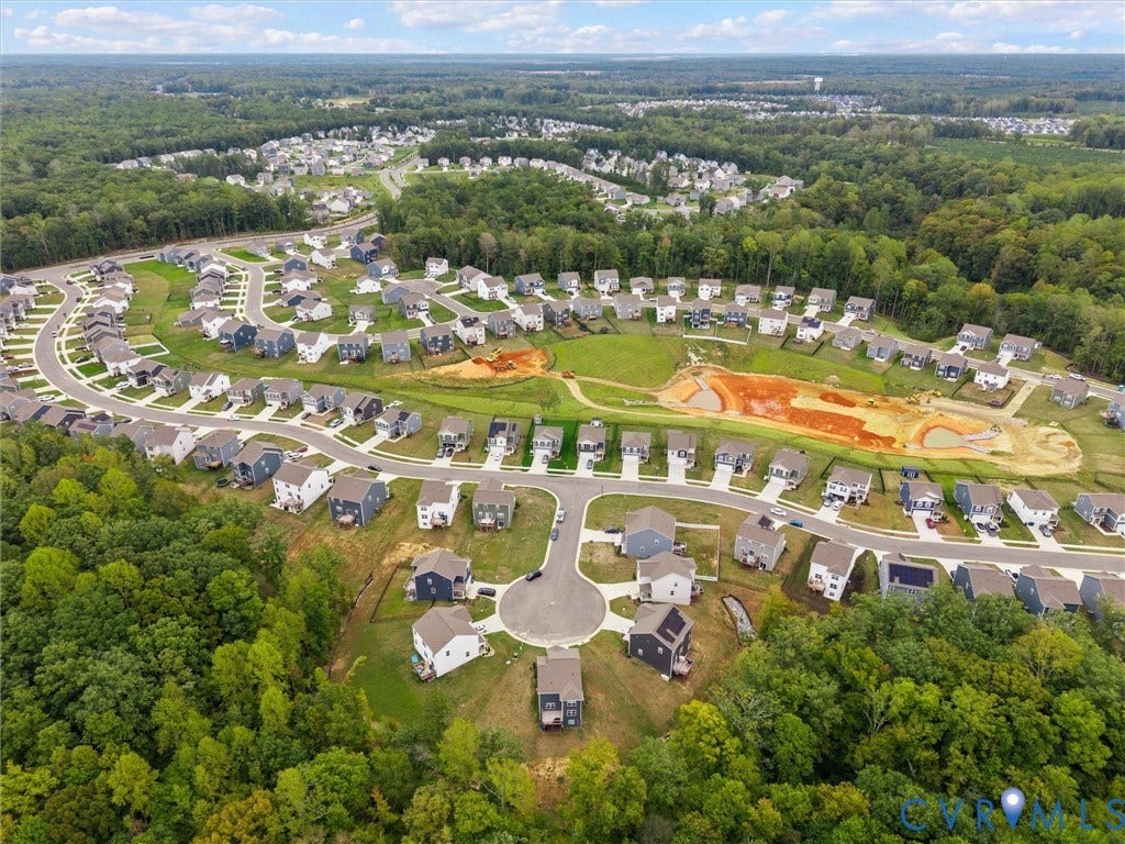 6901 Switch Cane Court, The Arbors, New Kent, VA 23141 Expansive residential development featuring numerous homes, paved roadways, and surrounding natural tree lines