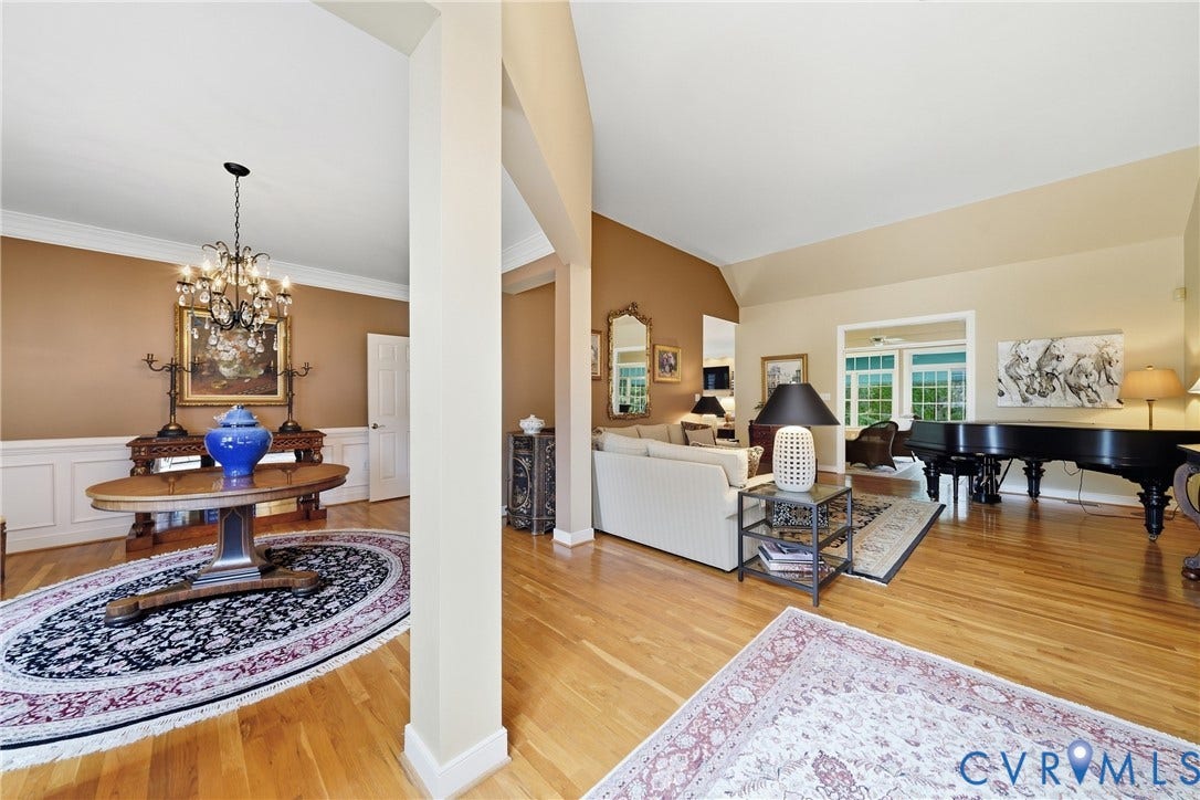 Hardwood flooring throughout, vaulted ceilings, wainscoting, and crown molding