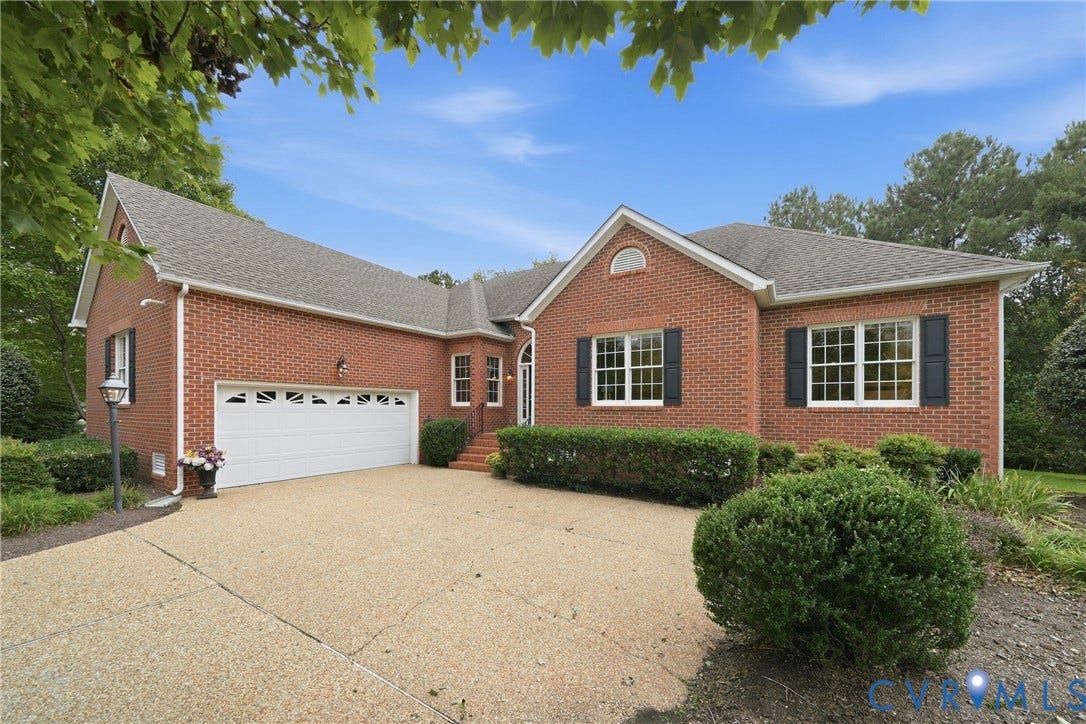 Brick exterior with black shutters and a two-car garage