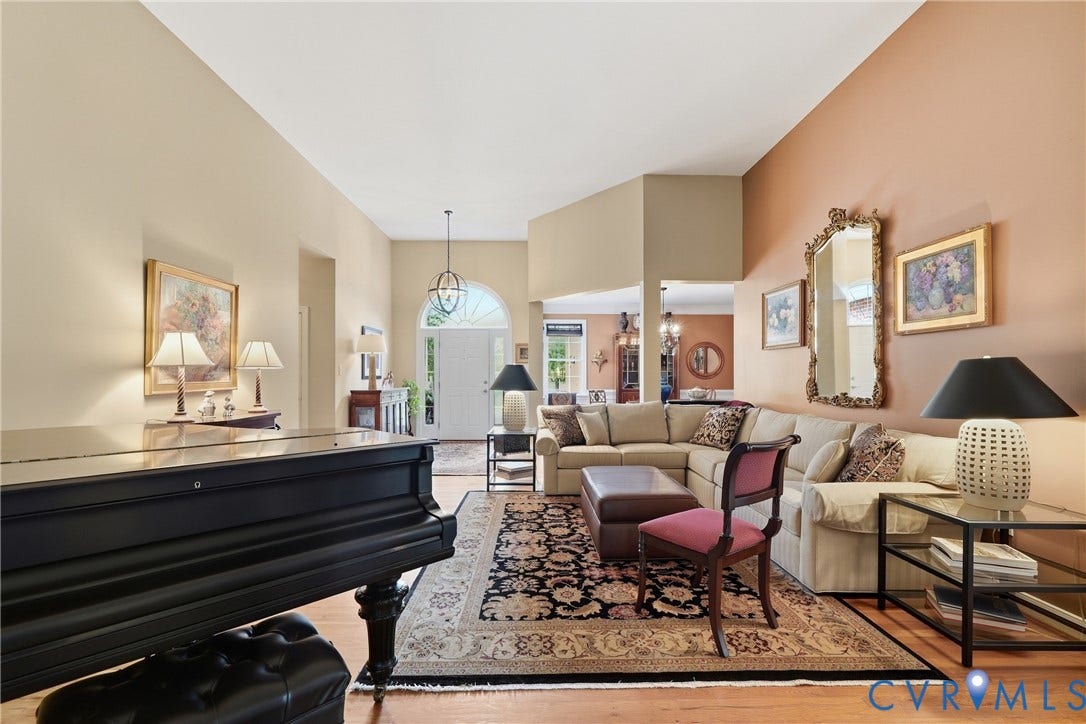 Vaulted ceiling, arched entryway, wood-finish flooring, recessed lighting, and an open-concept layout