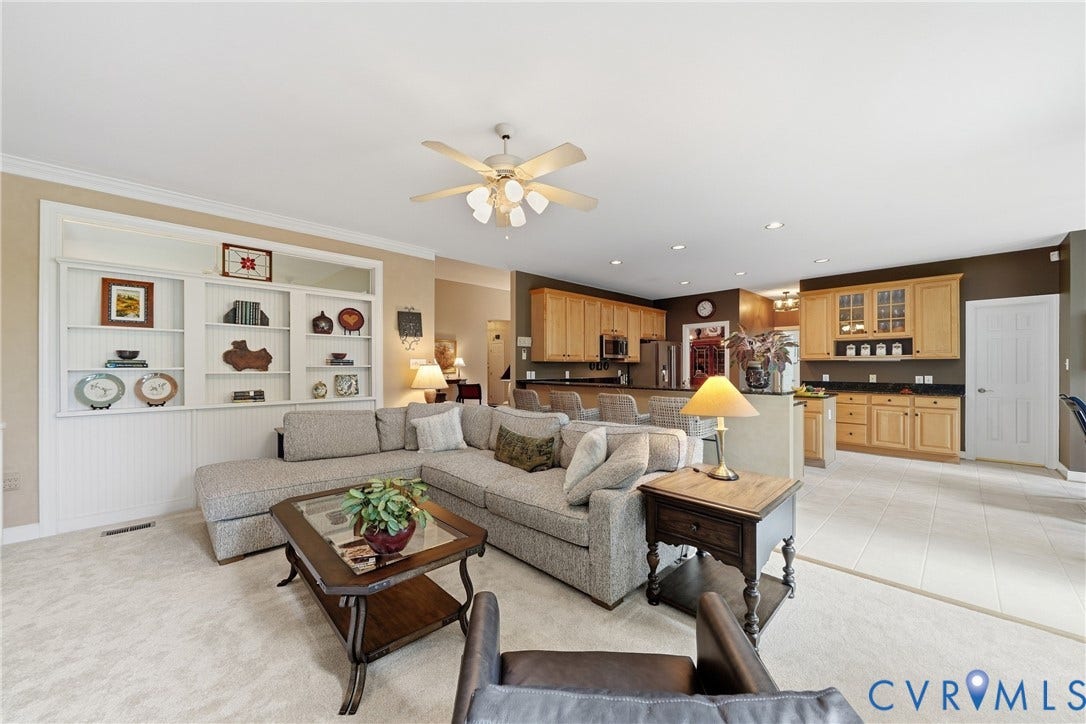 Built-in shelving, recessed lighting, ceiling fan, wood-finish cabinetry, and tiled flooring