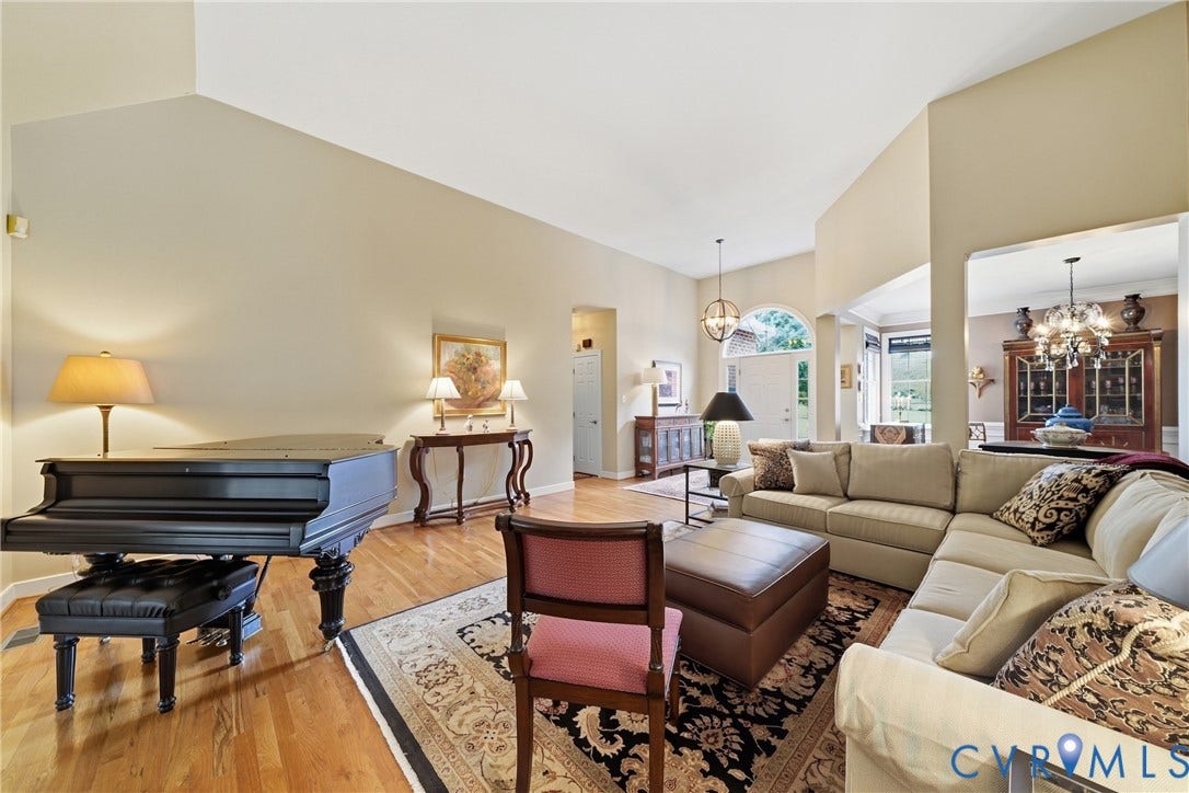 Vaulted ceilings, hardwood flooring, arched doorway, and recessed lighting