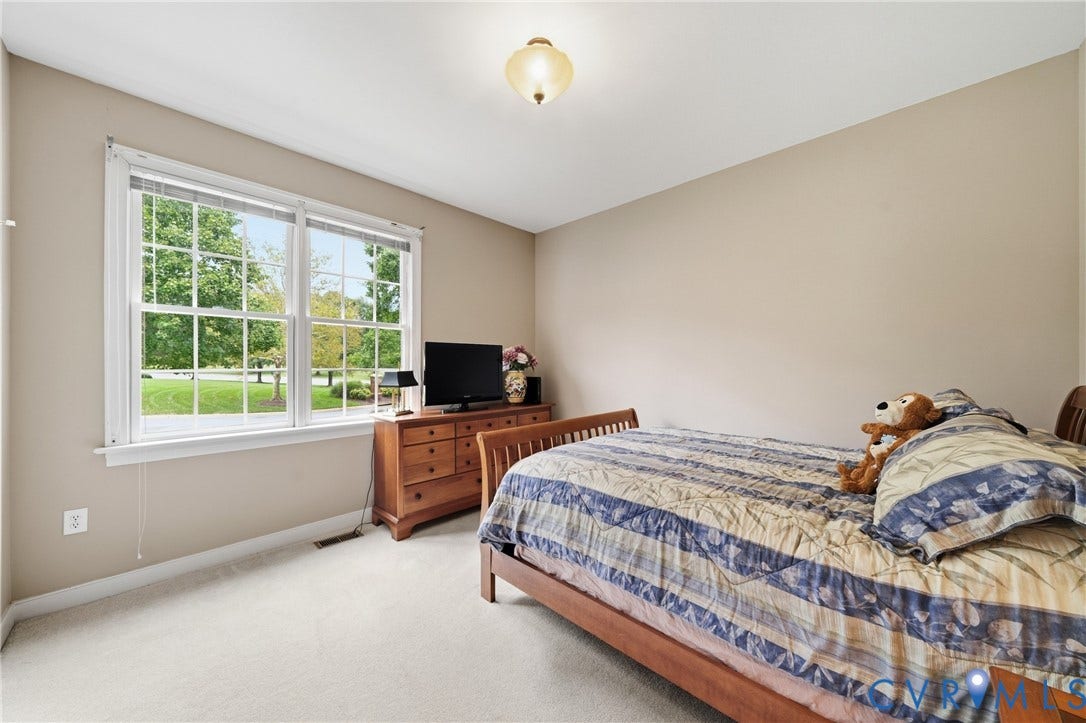 Neutral wall color, white trim, and light-colored carpet flooring