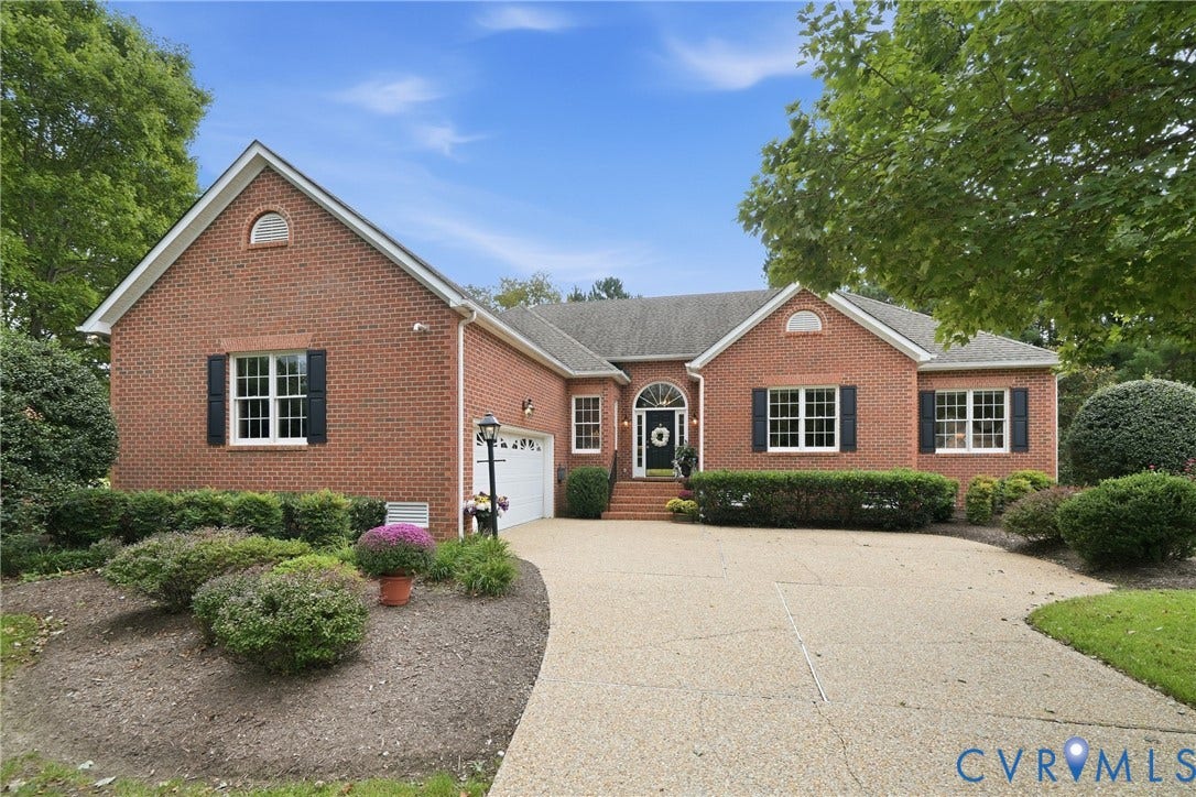 Brick exterior with black shutters and white window frames