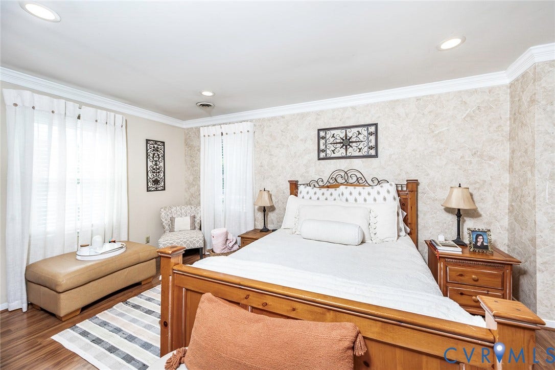 Recessed lighting, crown molding, wood-finish flooring, two windows, and textured wall covering
