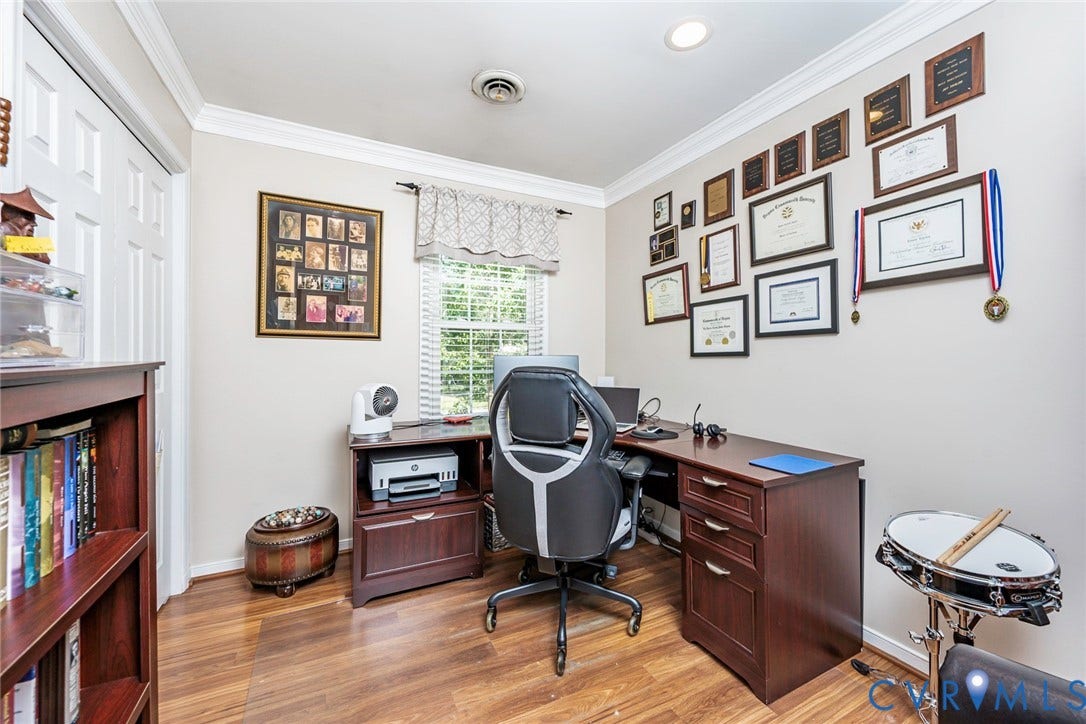 Recessed lighting, crown molding, wood-finish flooring, built-in shelving, and a paneled door