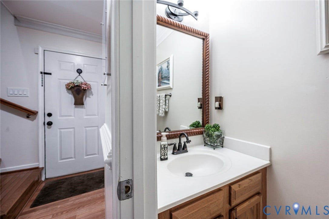 White paneled entry door with dark hardware