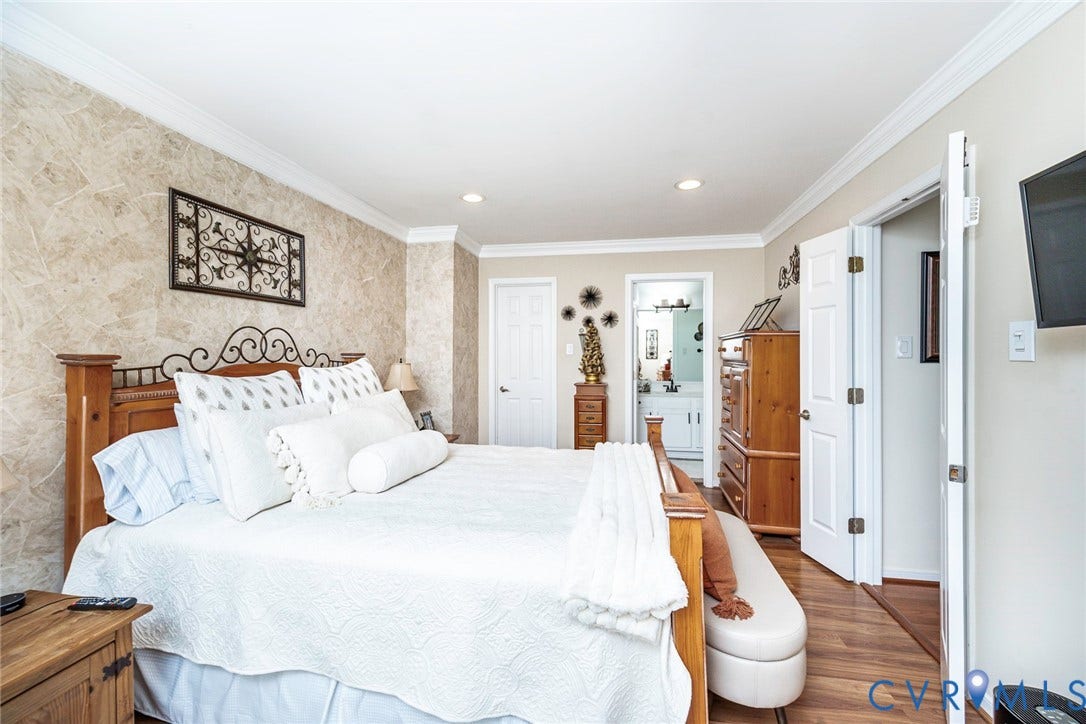 Recessed lighting, crown molding, and wood-finish flooring